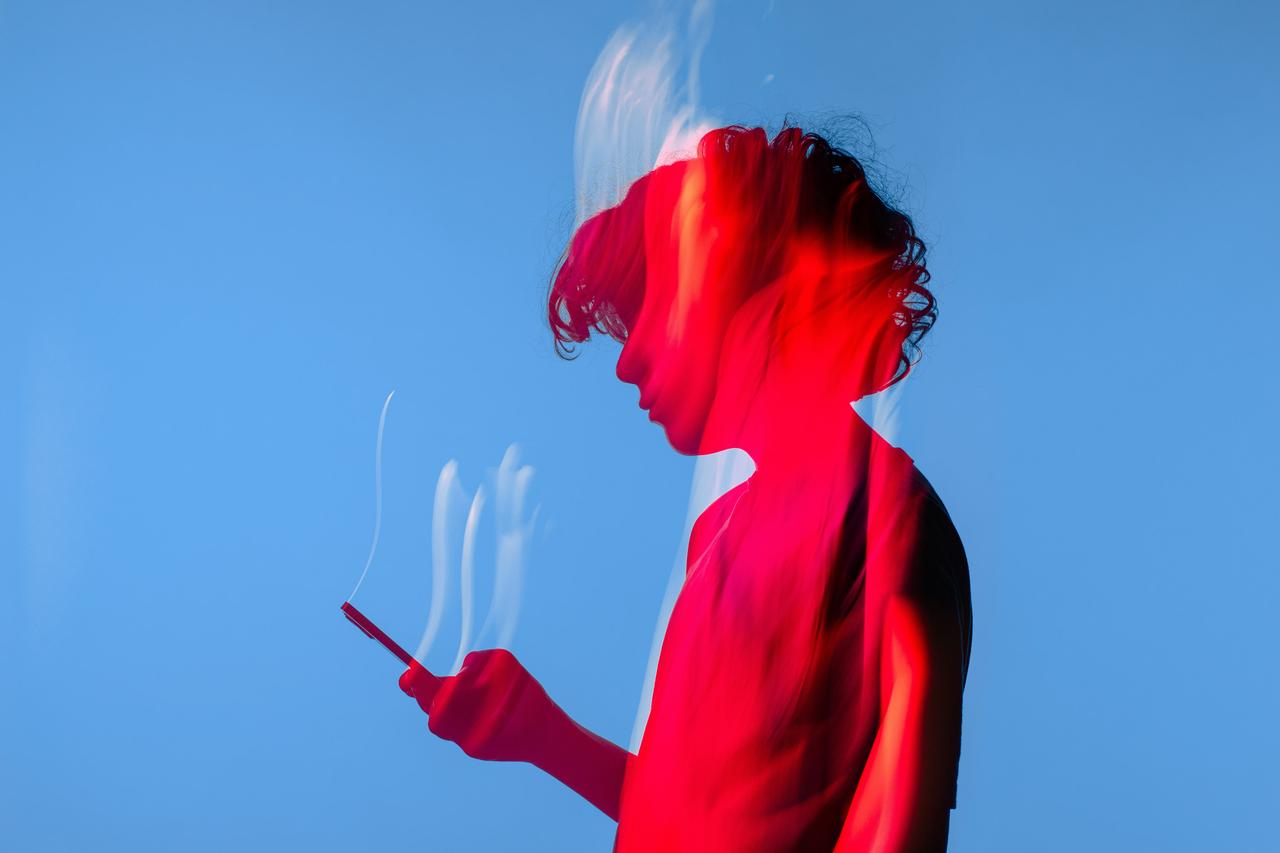 image of a woman looking at her phone